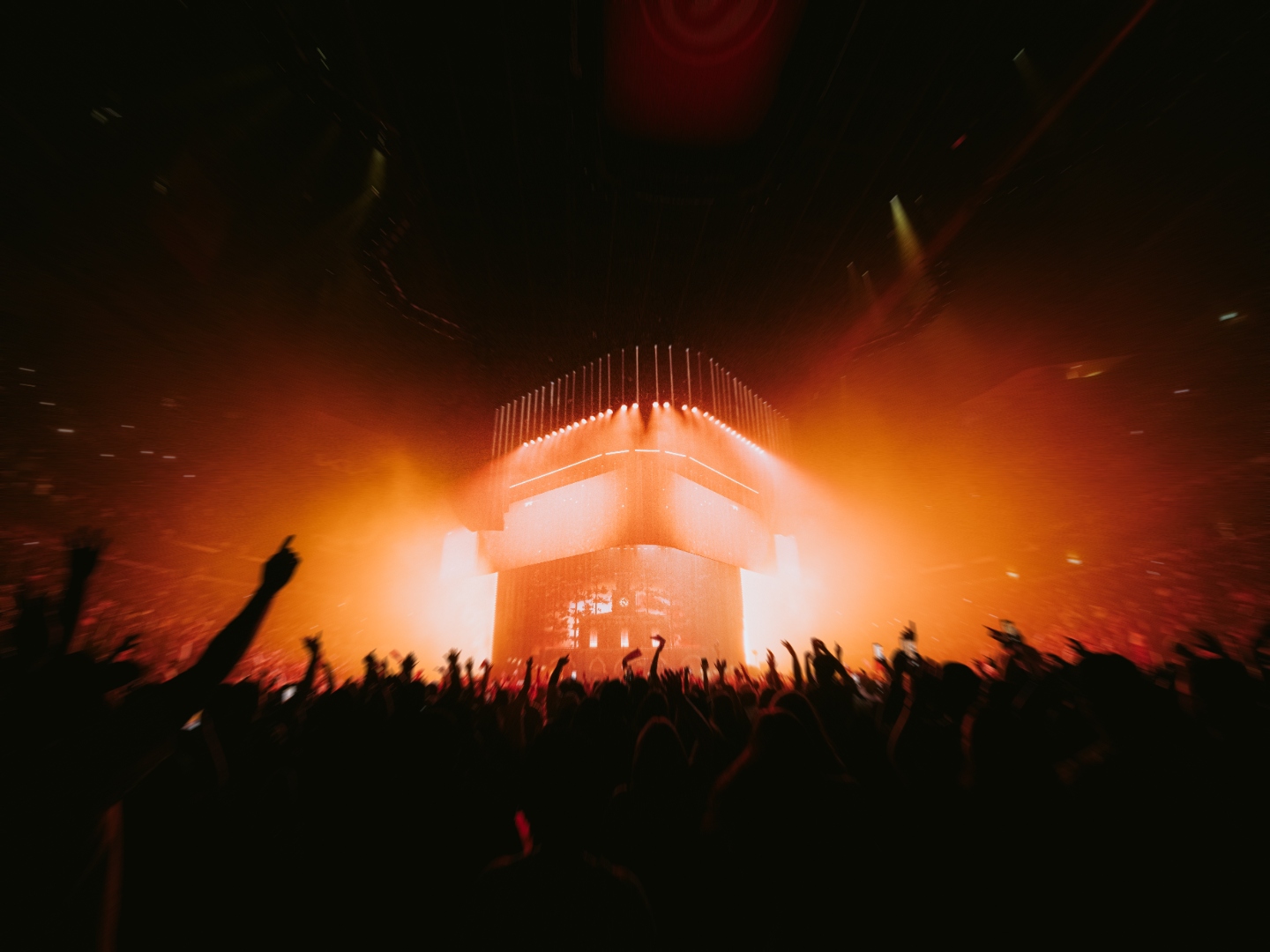Orange-lit stage cube surrounded by the crowd in Atlanta
