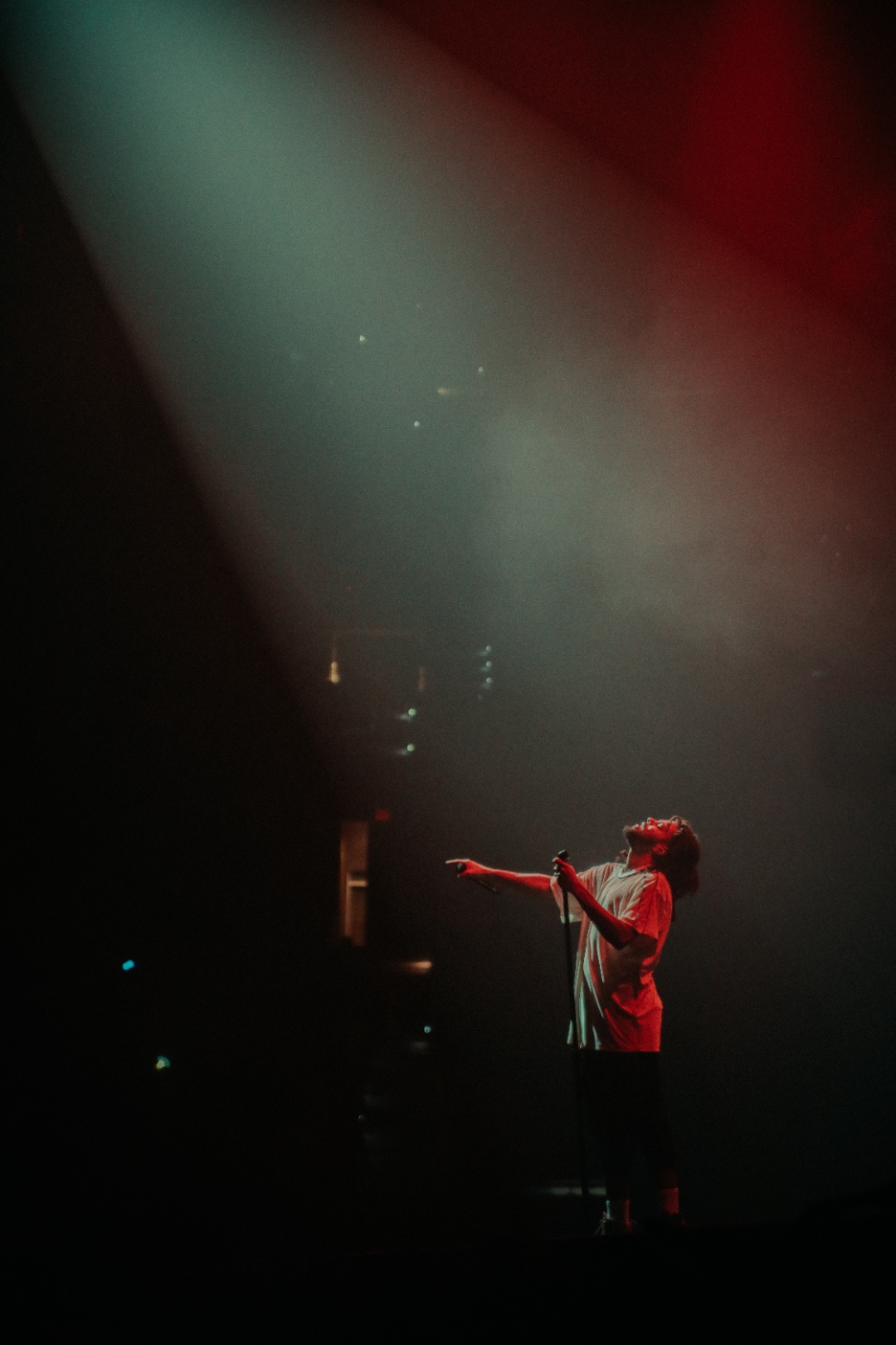 J. Cole in blue stage light