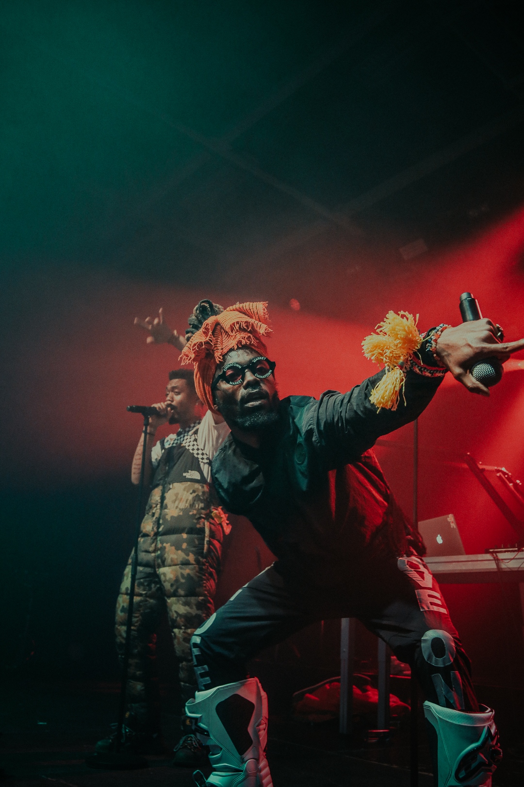 EarthGang under red haze with orange headwrap