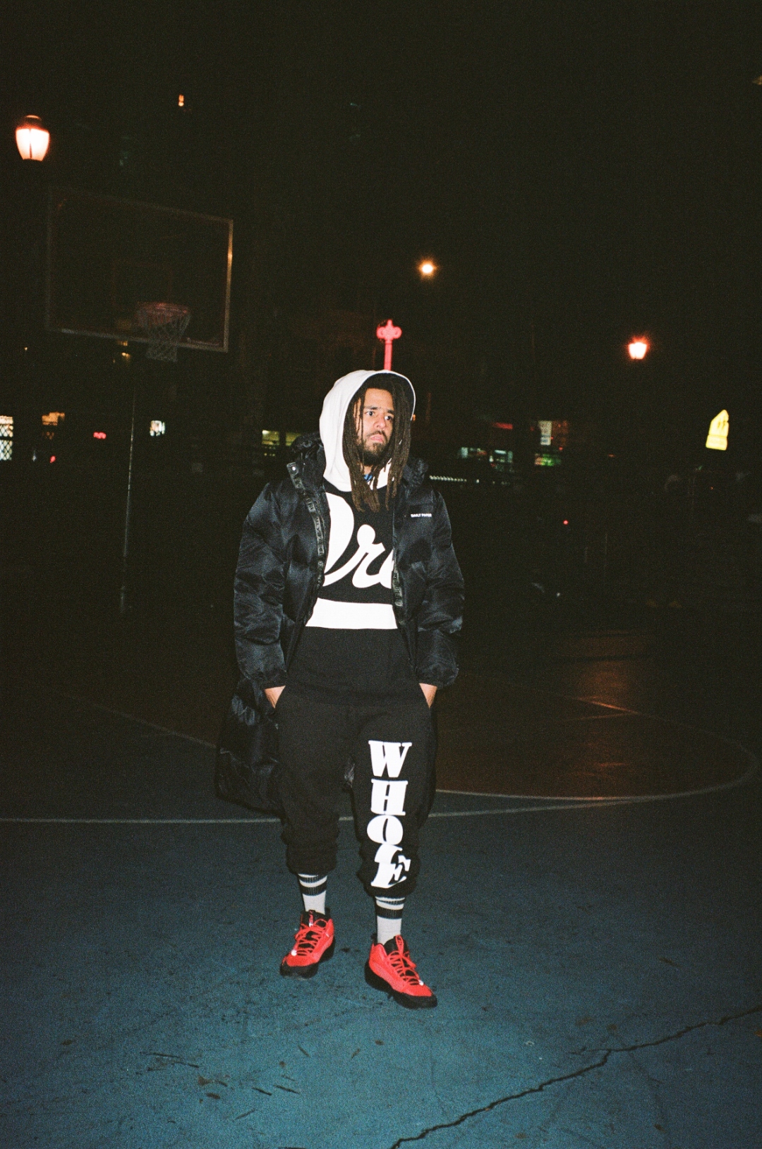 J. Cole on basketball court at night